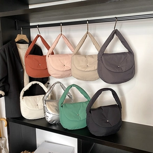 Quilted puffer tote bags in eight colors with wide handles and snap closure