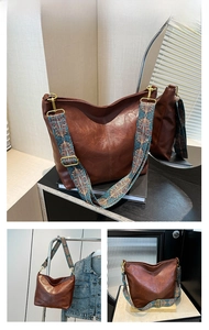 Detail of brown leather hobo bag featuring ethnic printed wide shoulder strap and hardware