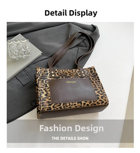 Detail of leopard print tote bag featuring a leather front pocket with fashion text