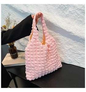 Detailed view of pink bubble textured tote bag with wide handle and soft fabric finish
