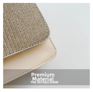 Detailed view of glittering gold fabric texture and smooth beige leather stitching