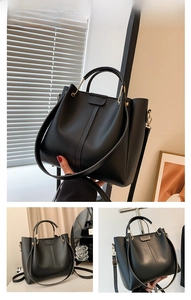 Close-up of black PU leather tote bag with U-shaped metal handle and adjustable strap