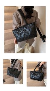 Detail of black quilted puffer tote bag with V-shaped stitching and ruched bubble strap