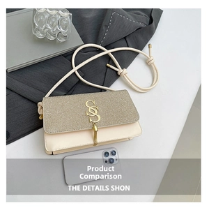Detail of cream beige shoulder bag with golden S logo, fringe tassel and glitter flap
