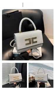 Detailed view of silver glitter handbag featuring a gold-toned double-E metal buckle