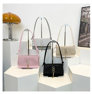 Close-up of glitter flip small square bags with metal logo and tassel charms in four colors