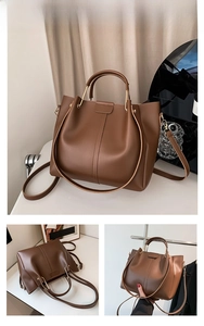 Detailed view of the brown PU leather tote bag with gold metal handles and modern texture