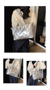 Detail of silver quilted tote bag featuring metallic finish and ruffled shoulder strap