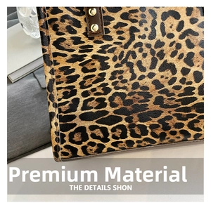 Detail of leopard print tote bag with metallic gold rivets and textured leather handles
