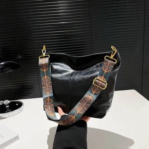 Black leather hobo bucket bag with vintage ethnic geometric patterned wide shoulder strap
