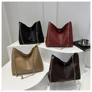 Group display of woven tote bags in four colors with gold chain straps and metal hardware