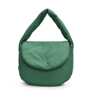 Quilted puffer saddle bag in dark green nylon featuring a metal magnetic buckle closure