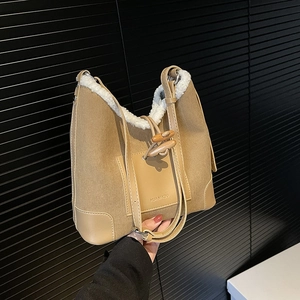 Khaki corduroy shoulder bag with faux shearling trim and wooden horn button detail