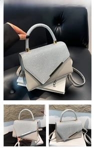 Detail of silver sequined flap handbag with smooth leather base and golden hardware
