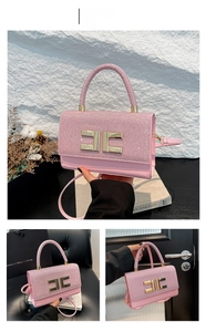 Pink glitter crossbody bag with gold C-logo buckle and cylindrical top handle detail