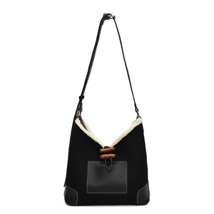 Black vintage shoulder bag with off-white fleece trim and wooden horn button closure