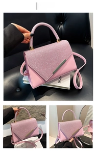 Macro shot of pink rhinestone handbag with gold metal edges and adjustable shoulder strap