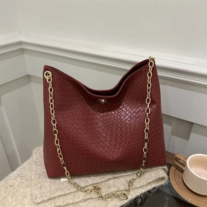 Retro burgundy woven tote bag with chunky gold chain strap and metallic twist lock clasp