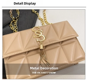 Detail of beige quilted shoulder bag with gold metal logo, tassel, and chain strap
