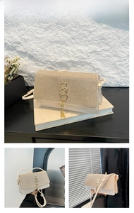 Macro view of khaki chain bag featuring sparkling rhinestones and a gold tassel charm
