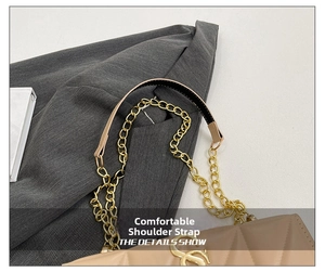 Detail shot of beige quilted faux leather texture with golden chain strap and logo