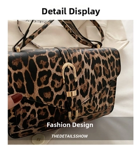 Close-up of leopard print crossbody bag featuring a premium gold horseshoe buckle detail