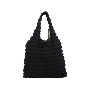 Minimalist black puff tote bag with popcorn texture and soft shoulder handle