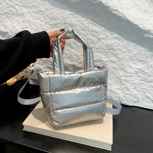 Modern silver quilted tote bag with metallic finish and adjustable strap for women