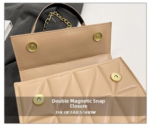 Detail of the beige quilted crossbody bag showing dual magnetic snap closures and chain