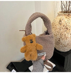 Detail of plush faux fur tote bag in grey-purple with a cute teddy bear charm