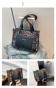 Detail view of leopard print patchwork tote with gold FASHION & BAGS lettering and rivets