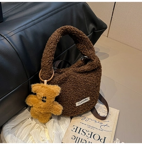 Detail of coffee plush bucket bag with cute bear charm and woven shoulder strap