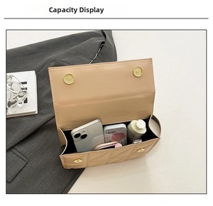 Internal capacity of beige quilted shoulder bag with cosmetics and phone inside