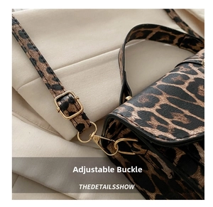 Detail of leopard print crossbody bag showing the adjustable gold metal strap buckle