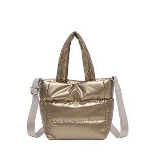 Quilted gold puffer handbag with glossy finish and adjustable shoulder strap for women