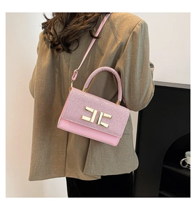 Detail of pink patchwork crossbody bag with golden EF metal logo and adjustable strap