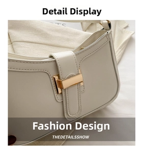 Close-up of cream leather shoulder bag with elegant gold buckle and precise stitching