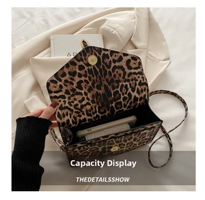 Detailed view of the internal storage space of the vintage leopard print crossbody bag