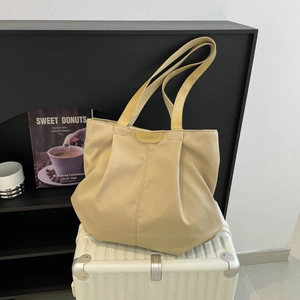 Minimalist beige pleated tote bag in durable nylon for casual travel and daily shoulder wear