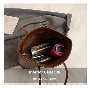 Detailed interior of the brown leather tote showing large capacity and internal pockets