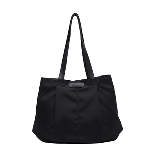 Minimalist black tote bag with fashion leather tag and stylish pleated nylon design
