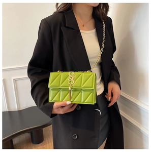 Chic green quilted crossbody bag with gold chain strap shown from a 45-degree angle