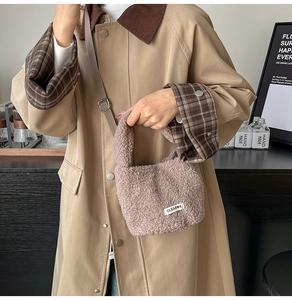 Close-up of plush mauve bucket bag with soft faux fur texture and Clear K woven label