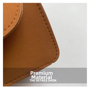 Gros plan sur la texture du cuir marron à motif litchi avec coutures nettes sur le sac
