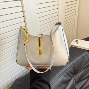 Silver metallic underarm bag with gold lock and chain detail in a modern fashion style