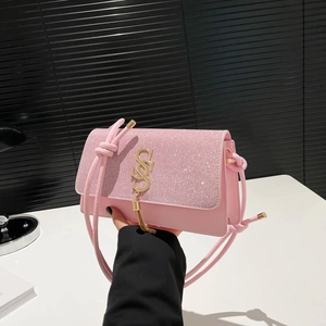 Pink glitter crossbody bag for women with gold metal logo and stylish tassel detail
