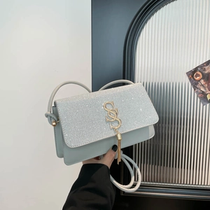 Light blue chic crossbody bag with silver sequins, gold S hardware and tassel detail