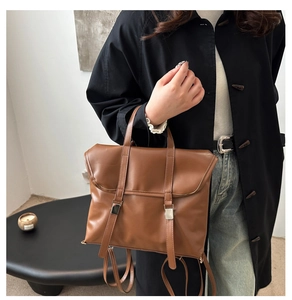 Detail view of the brown vintage PU leather backpack with silver metallic buckle straps