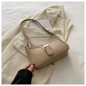 Detail of khaki retro shoulder bag with golden metal buckle and minimalist stitching