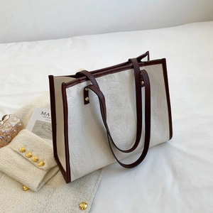 Minimalist large-capacity cream tote bag with embossed textures and brown shoulder straps